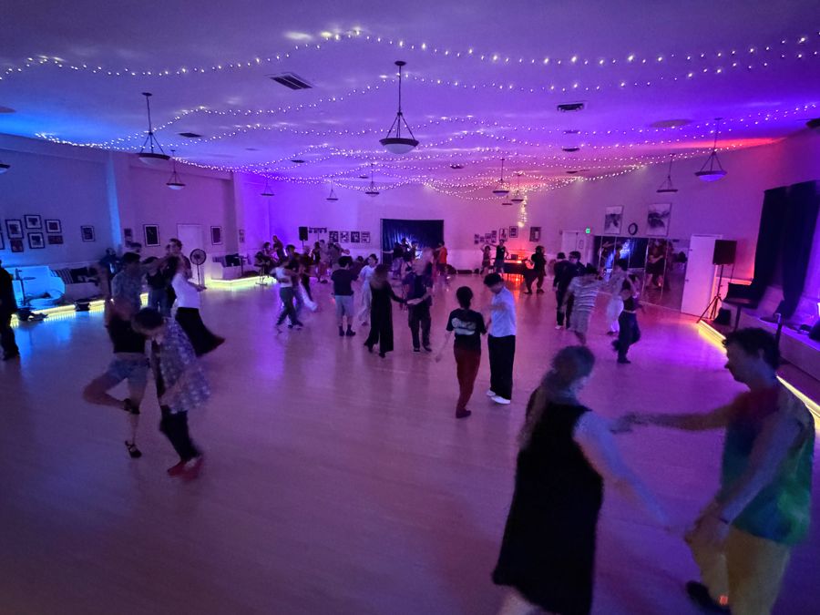 The Luna del Soul ballroom during a Solar Fusion night, lit purple and blue with fairy lights overhead